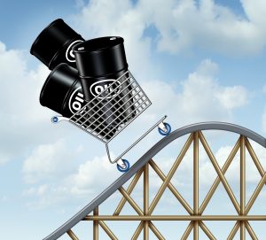 Rising oil prices with a group of oil barrels or steel drum containers in a shopping cart going up on a roller coaster as a business concept of high fuel costs and the unstable nature of energy value.